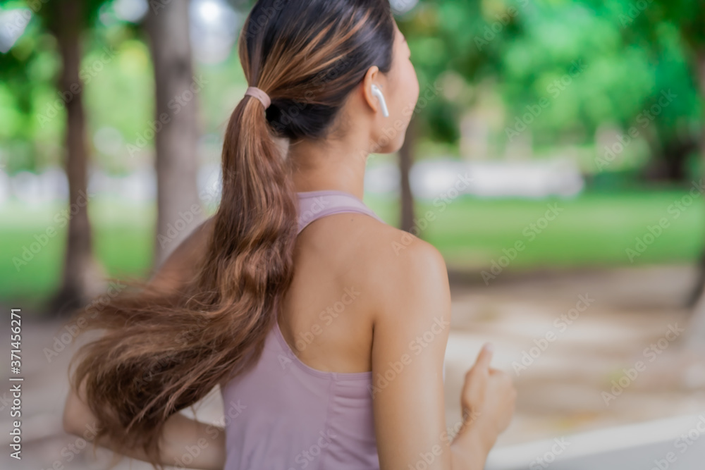 Young woman doing running exercises in the park. Young woman doing running exercises in the park.