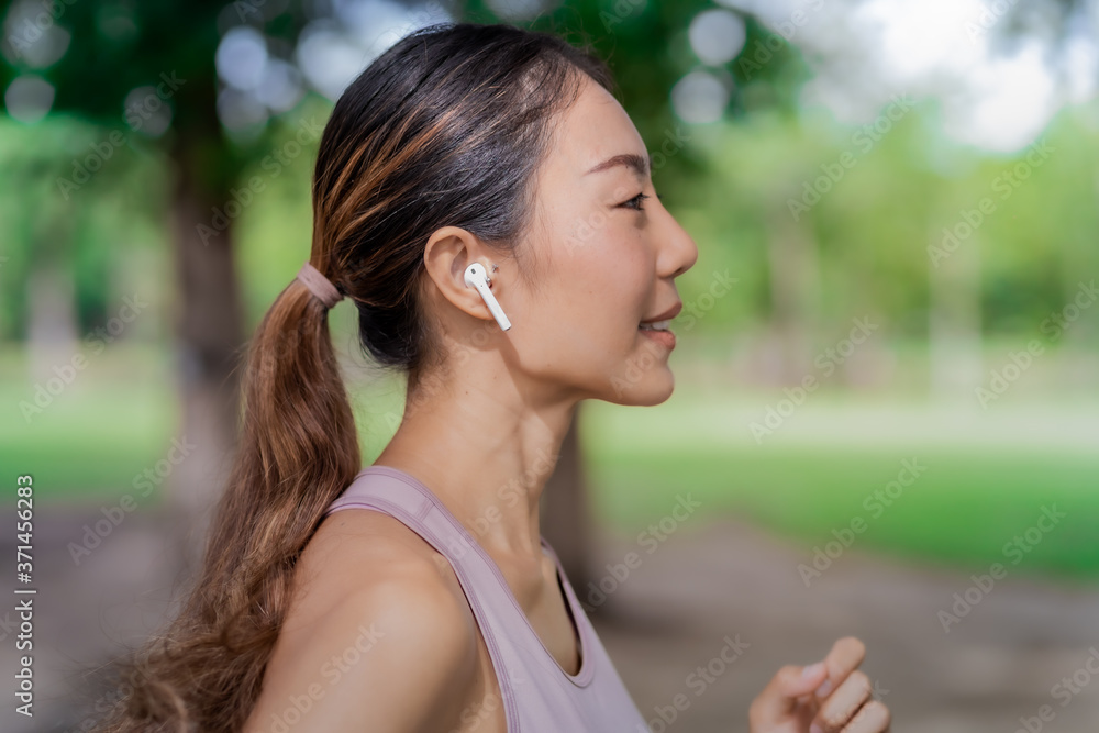 Young woman doing running exercises in the park. Young woman doing running exercises in the park.
