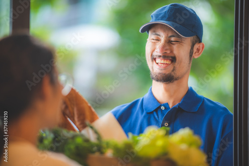 The Asian delivery man give...