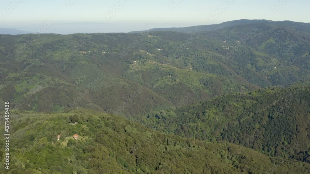 Flight with a drone over a beautiful vast and rural mountain terrain with a scenic panorama on a cloudless sunny day Flight with a drone over a beautiful vast and rural mountain terrain with a scenic panorama on a cloudless sunny day