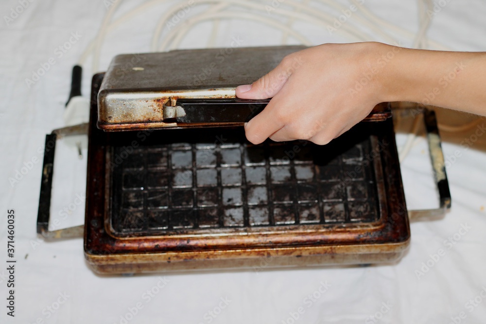 custom made wallpaper toronto digital
Vintage cast iron waffle iron and hand.
