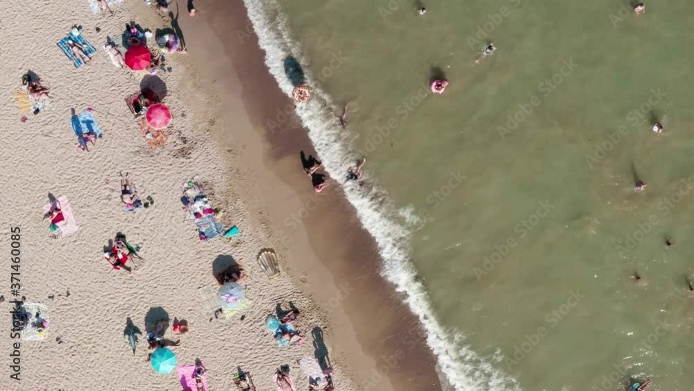Aerial view. People sunbathe and swim on the beach at the seaside. Sandy beach on the Black Sea with muddy water. Beach in Odessa in Ukraine Aerial view. People sunbathe and swim on the beach at the seaside. Sandy beach on the Black Sea with muddy water. Beach in Odessa in Ukraine