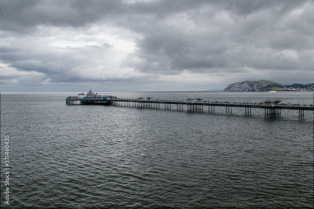 holiday pier under dark clouds
