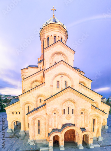 Close up view of the Sameba holy trinity cathedral with dark blue sky and rainbow in the background. Religion and historical sites in Georgia.