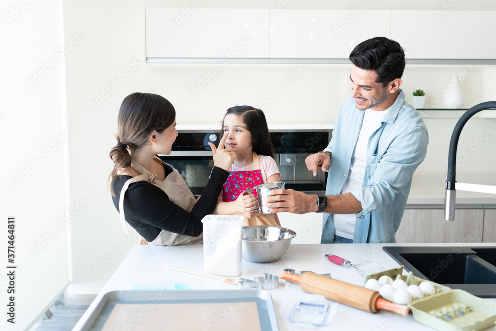 Smiling Man With Family Cooking At Home Smiling Man With Family Cooking At Home