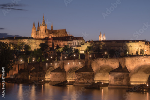 Prague Cityscape at Night with Saint Vitus Cathedral and Charles Bridge in a Nostalgic Vintage Look