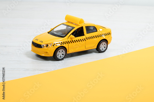 Yellow taxi on a light background. Taxi