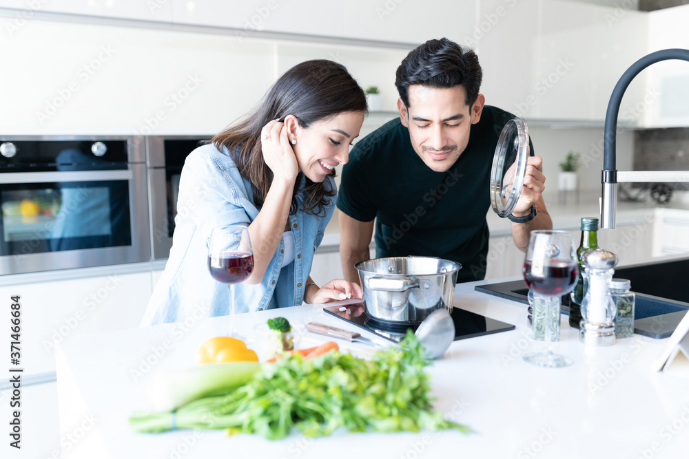 Couple Preparing Food In Kitchen At Home Couple Preparing Food In Kitchen At Home