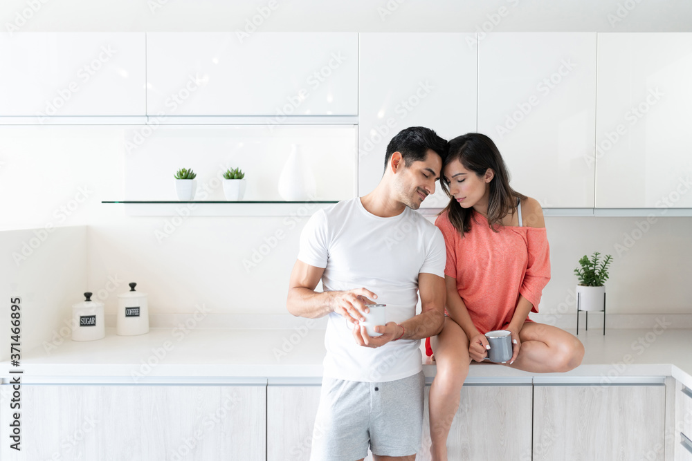 Affectionate Hispanic Couple In Kitchen At Home Affectionate Hispanic Couple In Kitchen At Home