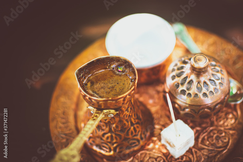 Turkish coffee set up with freshly made coffee and candy with toothpick in Bosnian restaurant. Tourism and traditional drinks.