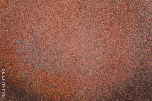 Rusty metal texture with dark corners at the bottom.