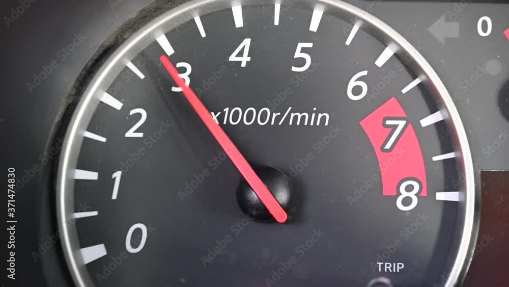 The tachometer on the vehicle dashboard. Red arrow shows number of engine speed The tachometer on the vehicle dashboard. Red arrow shows number of engine speed