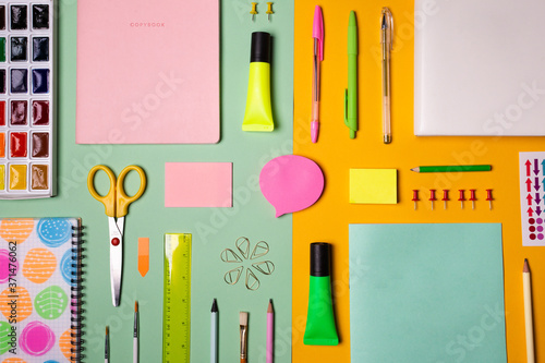 School tools and accessories on yellow and light green background
