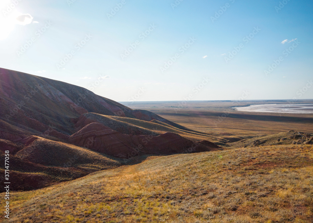 Big Bogdo mountain. Red sandstone outcrops on the slopes sacred mountain in Caspian steppe Bogdo - Baskunchak nature reserve, Astrakhan region, Russia.