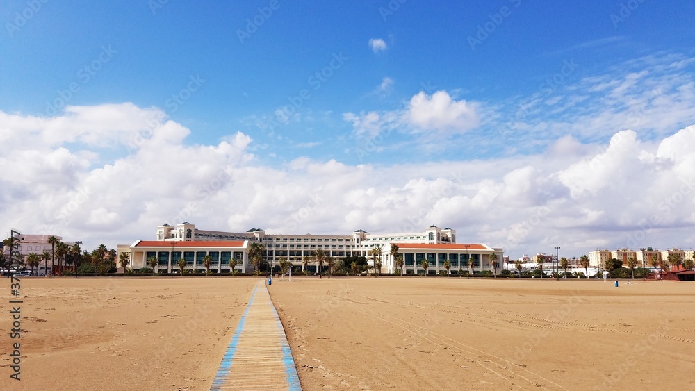 Family time leisure travel to sandy beach right to a luxury hotel resort in Valencia Spain Europe on a bright sunny weekend.