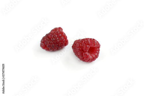 Two ripe juicy raspberries on a white background.