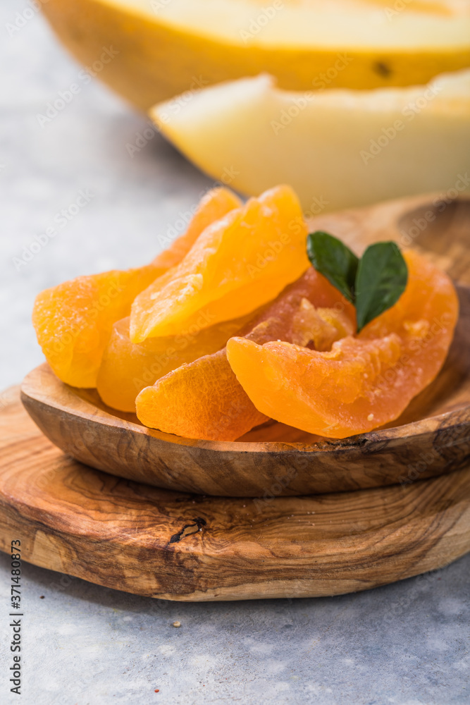 Candied Melon. Delicious sweet slices of yellow dried melon background