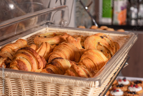 Croissants on a basket weave in a bakery shop.
