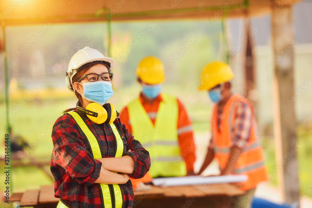 Corona or Covid-19 wear masks during the design of construction. New normal.Industrial engineering team wears a COVID 19 protective mask. Workers wear a quarantine face mask. Corona or Covid-19 wear masks during the design of construction. New normal.Industrial engineering team wears a COVID 19 protective mask. Workers wear a quarantine face mask.