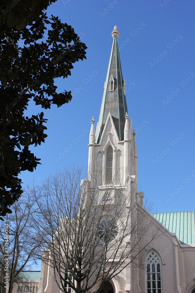 Baptist church spire against the blue sky. White church. Raleigh, NC