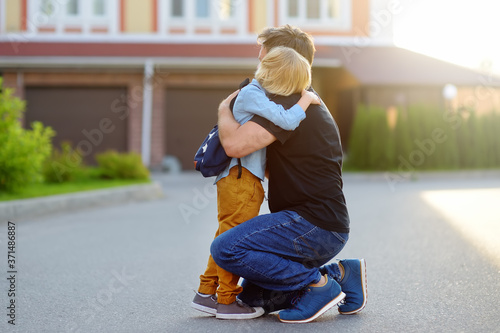 Konstfotografi Little boy says goodbye and hugging to his father before going to school