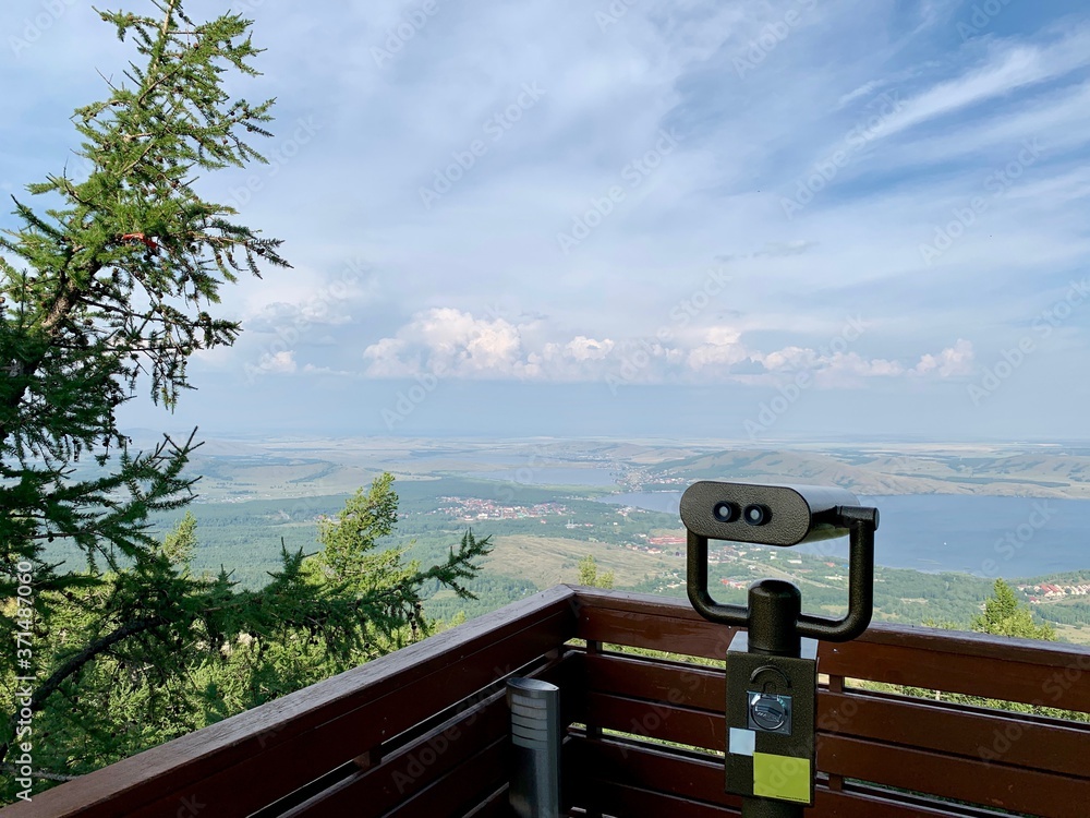 Panoramic beautiful landscape through a telescope at the top of the mountain