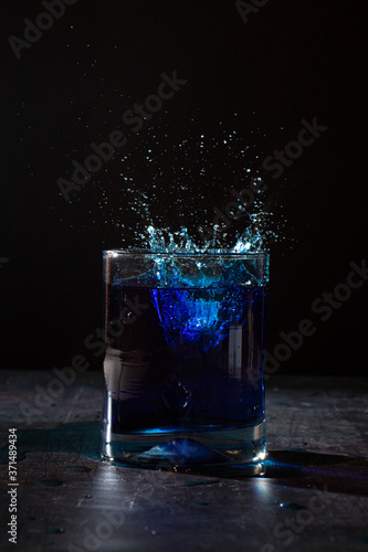 glass of water on dark background with a splash