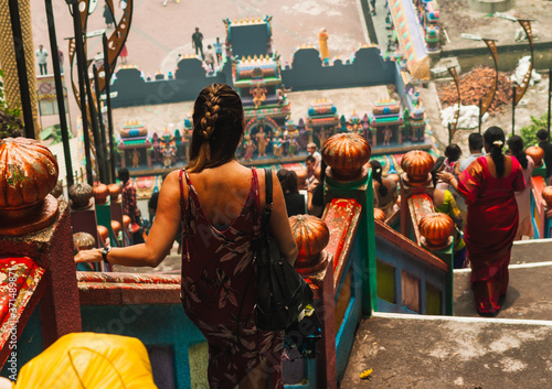 Photography A woman descends the steps of the Batu Caves in Malaysia, enjoying the spectacular views