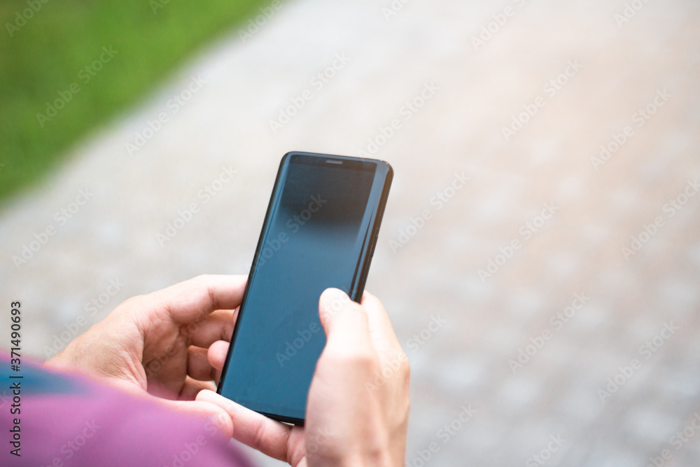 Close-up of men's hand holding a cell phone.