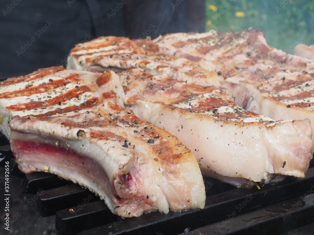 pork steaks on the bone on the grill. delicious pork loin steaks on the bone.