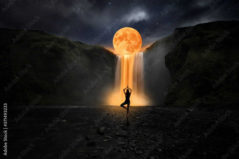 Woman doing yoga in front of a magic waterfall Stock Photo | Adobe Stock
