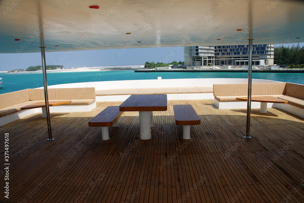 Fototapeta premium table and benches on the upper deck of the safari ship