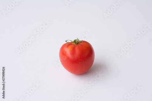 red tomato on a white background