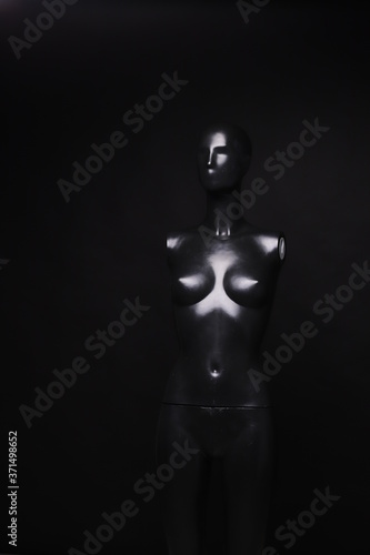 Abstract concept. Black dummy on black background. Studio shot. photo