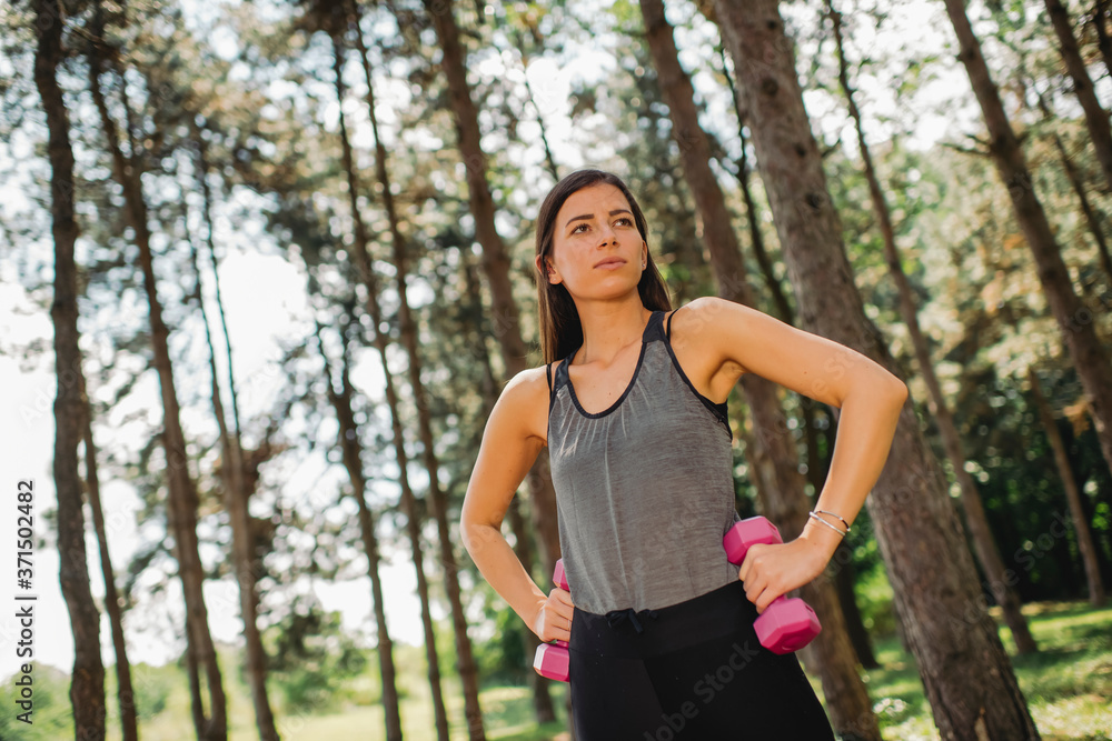 Young Caucasian woman working out with a dumbbells Young Caucasian woman working out with a dumbbells
