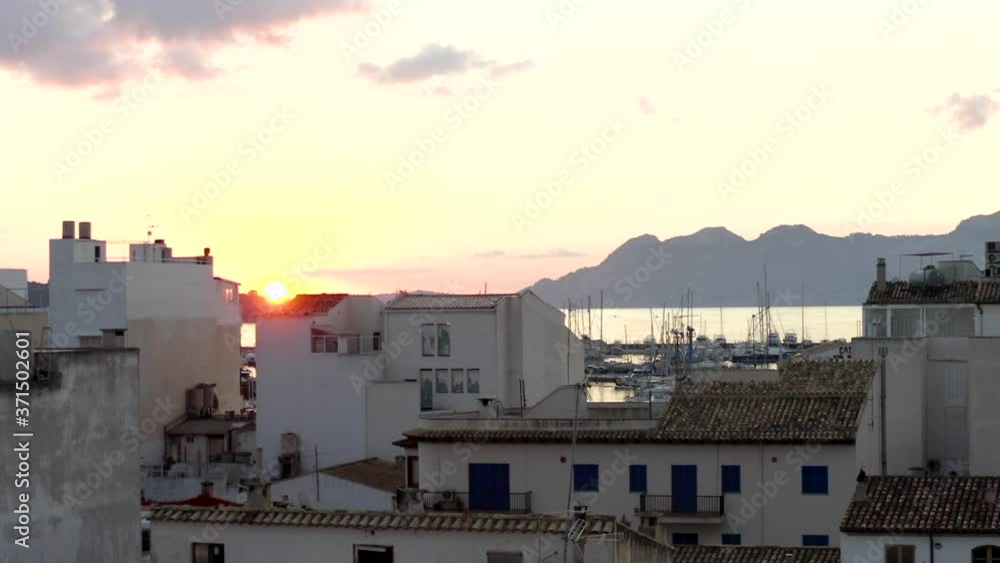 AERIAL: Small City with Port on Tropical Island with Boats and Ocean at Small Town at Sunrise with Mountains in Background Vacation, Travel, Sunset AERIAL: Small City with Port on Tropical Island with Boats and Ocean at Small Town at Sunrise with Mountains in Background Vacation, Travel, Sunset
