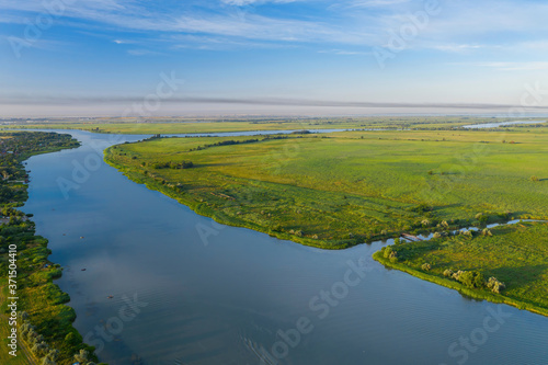 Aerial view of green meadow and beautiful river. Summer landscape.  © kolidzei