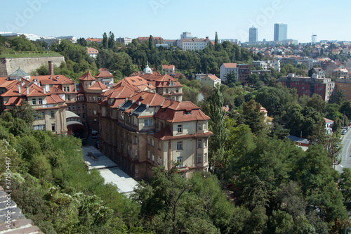 Panorama of the daytime Prague with red tile roofs.