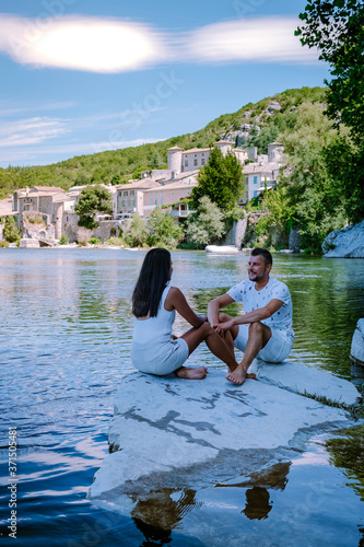 couple on vacation in Ardeche France, view of the village of Vogue in Ardeche. France Europe photo