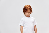 redheaded teen looking down white t-shirt cropped view studio 