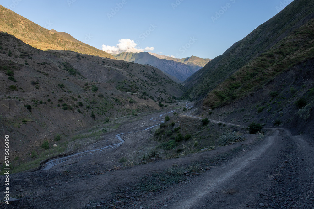 Mountain road spring ranges landscape. Mountain hill road panorama. Road on the background of mountains and sky