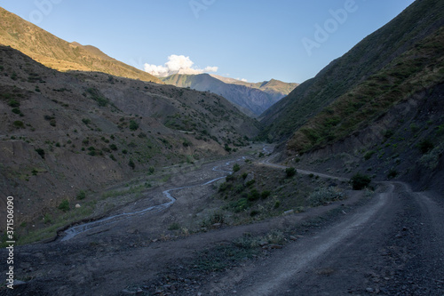Mountain road spring ranges landscape. Mountain hill road panorama. Road on the background of mountains and sky