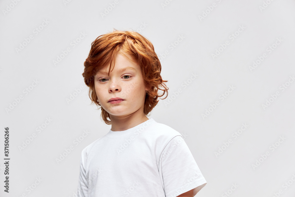 redhead boy brooding look down white t-shirt cropped view redhead boy brooding look down white t-shirt cropped view