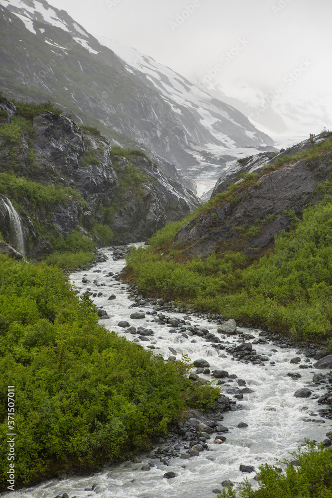 Rocky river flowing through snow covered mountains, Anchorage, Alaska, Denali National Park, United States Rocky river flowing through snow covered mountains, Anchorage, Alaska, Denali National Park, United States