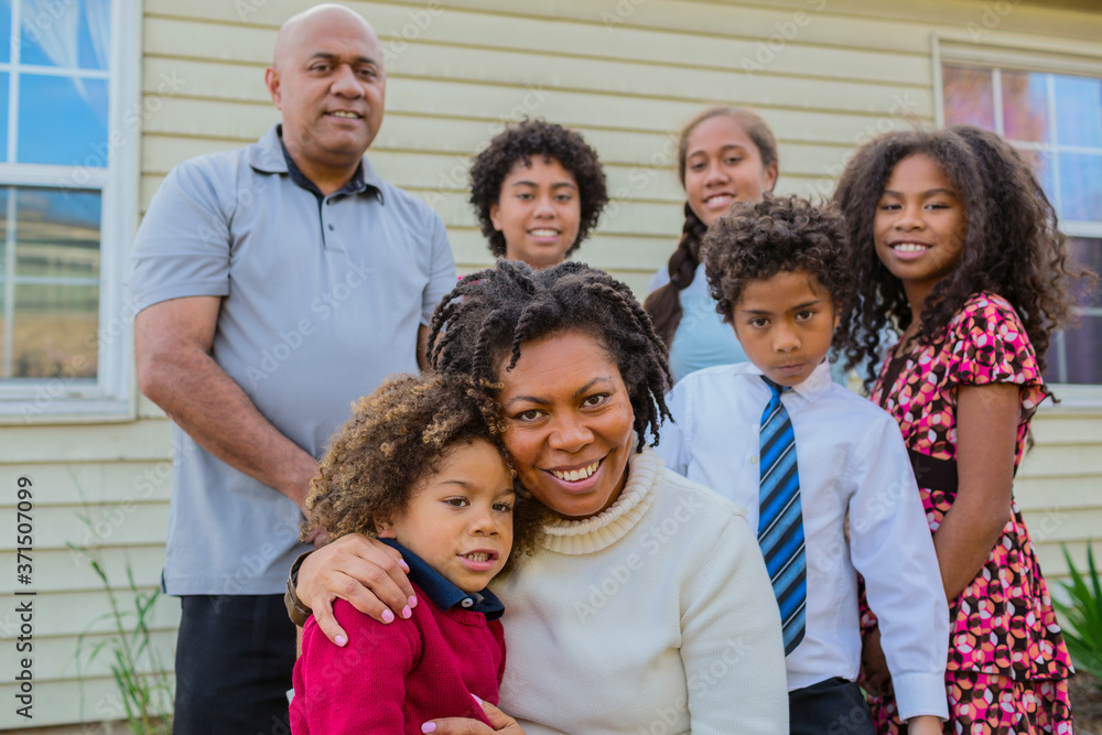 Pacific Islander family smiling outdoors Pacific Islander family smiling outdoors