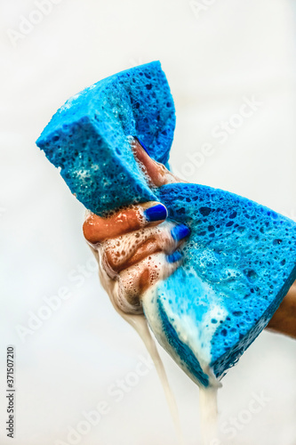 Chinese girl squeezing soapy sponge