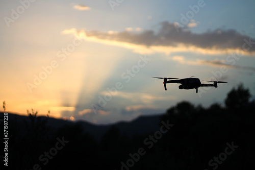 Photography stock photo of drone flying at sunset on the mountain