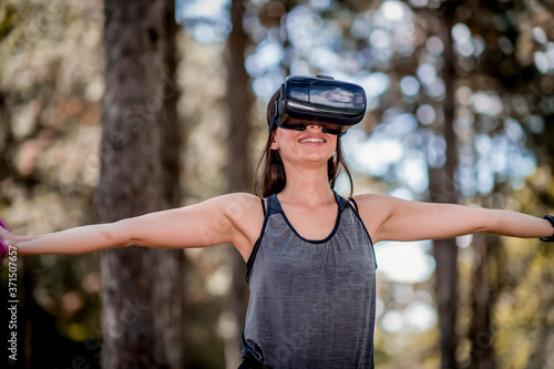 Beautiful young woman doing a workout with virtual reality headset