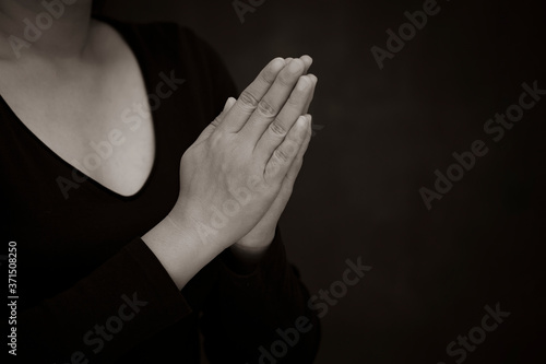 Praying and worship to GOD Using hands to pray with book in religious beliefs and worship christian in the church or in general locations in White and Black background