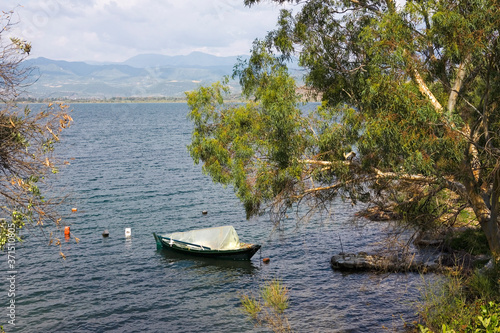 A lone fishing boat moored in a bay of Amvrakkios Gulf, Pigadaki, Amfilochia, Aetolia-Acarnania, Greece © Will Perrett
